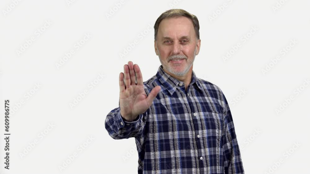 Portrait of mature senior man showing his palm as stop gesture sign. Isolated on white. Portrait of mature senior man showing his palm as stop gesture sign. Isolated on white.