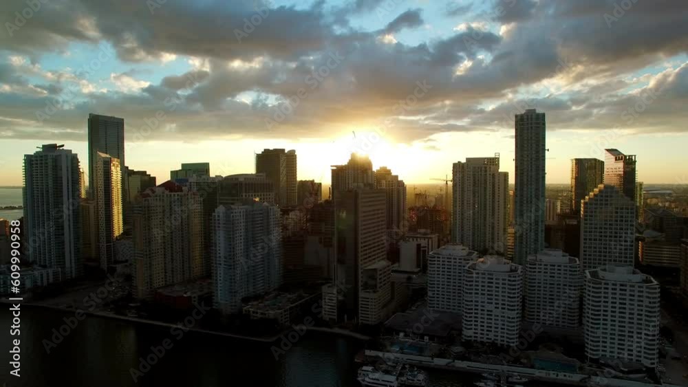 Aerial Panning Shot Of Modern Buildings By Sea Against Sky At Sunset, Drone Flying Over Coastline - Miami, Florida Aerial Panning Shot Of Modern Buildings By Sea Against Sky At Sunset, Drone Flying Over Coastline - Miami, Florida