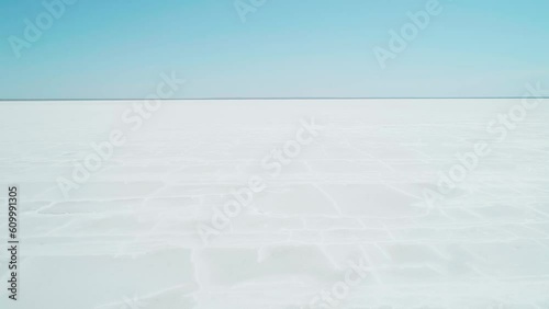 Aerial wide view of salt lake coast. Baskunchak in high tourist season at bright sunny day. Unique lake in the southwest of Russia, medicinal clay and mud deposite photo