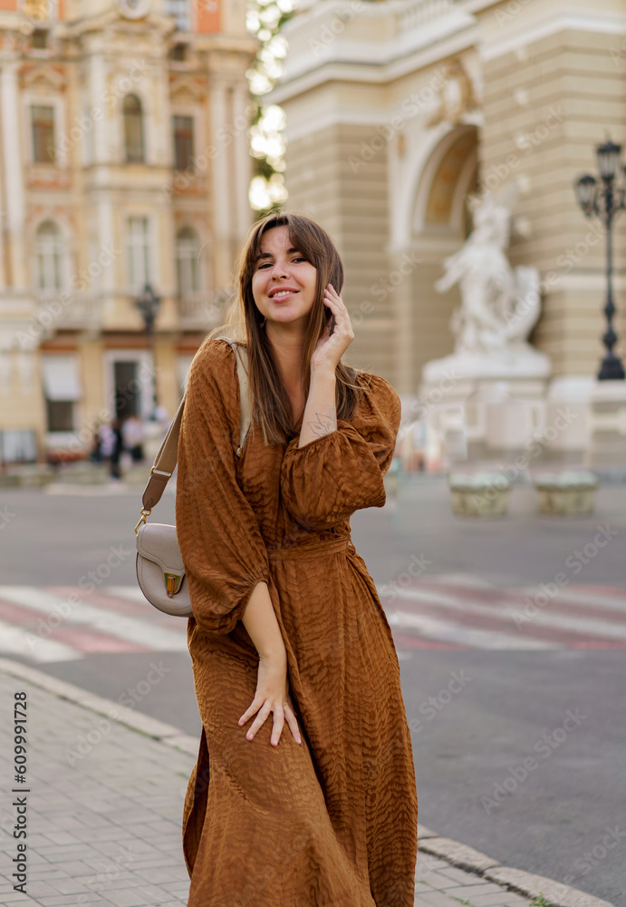 Beautiful smiling   woman  in summer dress walking  and enjoing vacations in Europe.