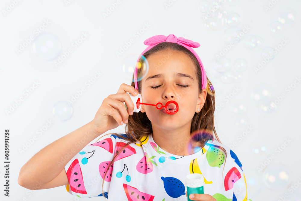 Little girl blowing bubbles in water of soap Little girl blowing bubbles in water of soap