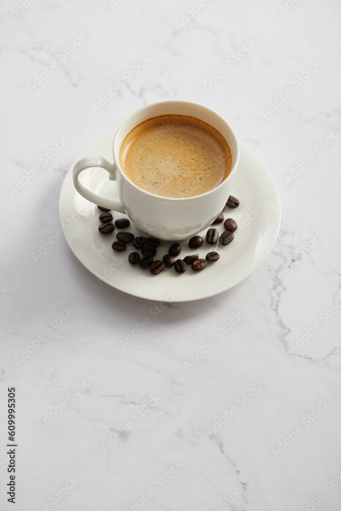 Cup of coffee and beans, on white marble table Cup of coffee and beans, on white marble table