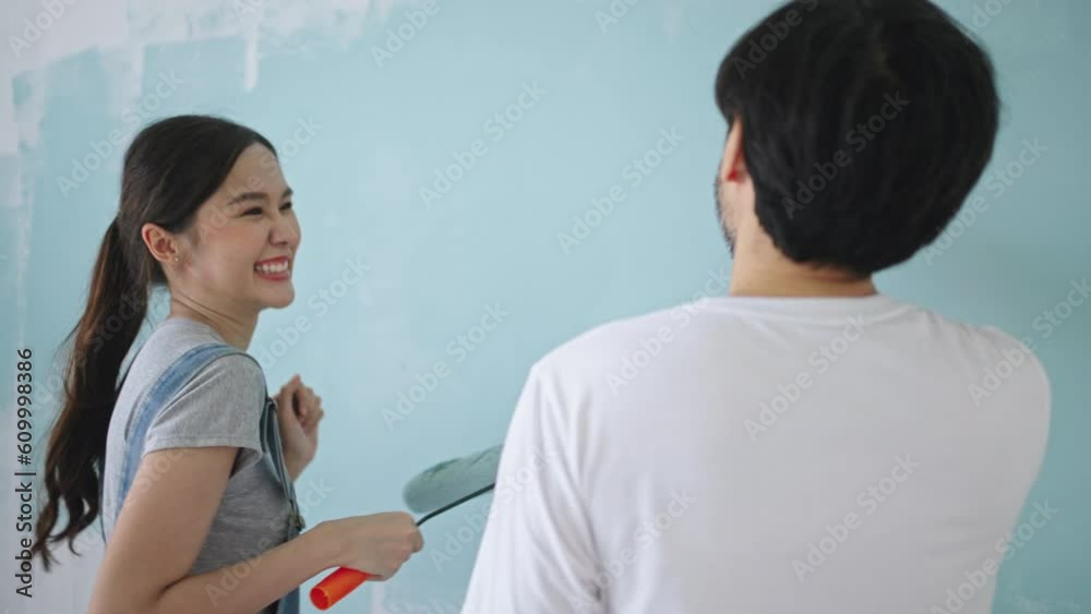 New home,Repair,happy,New life,insurance,carefree relationship,love lifestyle,renovation and decorating concept.Happy Young asian couple dancing making funny moves and painting walls at new apartment New home,Repair,happy,New life,insurance,carefree relationship,love lifestyle,renovation and decorating concept.Happy Young asian couple dancing making funny moves and painting walls at new apartment