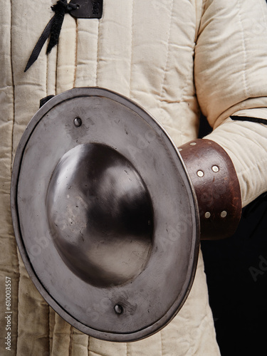 Man holding knight medieval buckler shield.