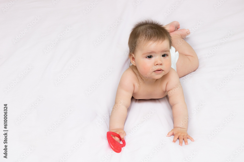 charming cute baby girl lies on her tummy on a light background with copy space charming cute baby girl lies on her tummy on a light background with copy space