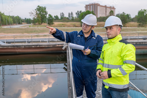 Environmental engineers work at wastewater treatment plants,Water supply engineering working at Water recycling plant for reuse,Technicians and engineers discuss work together. © reewungjunerr