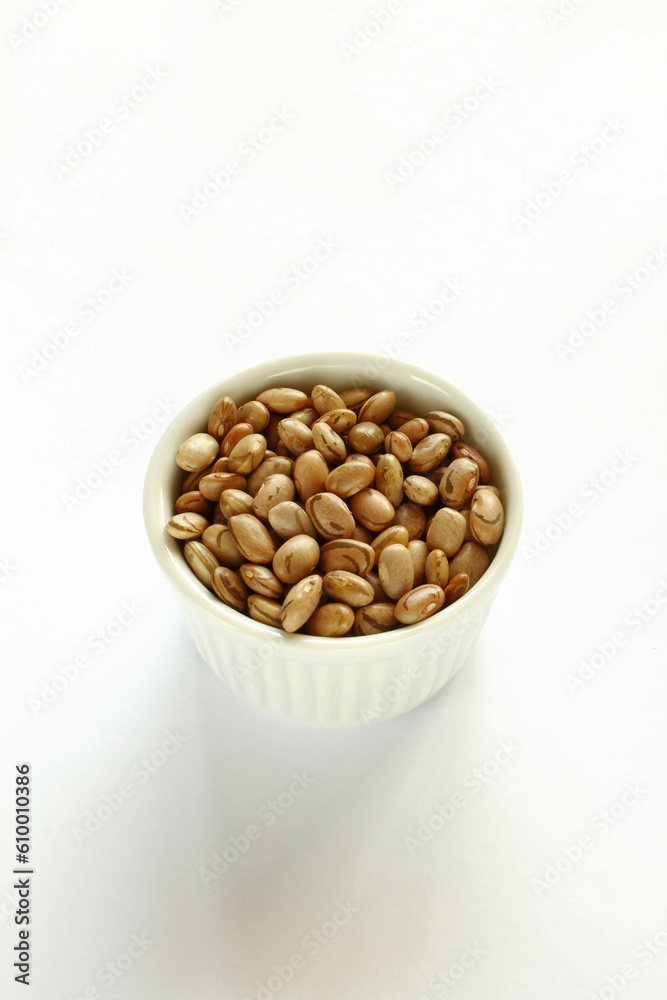 Carioca beans in a bowl on the white background. Carioca beans in a bowl on the white background.