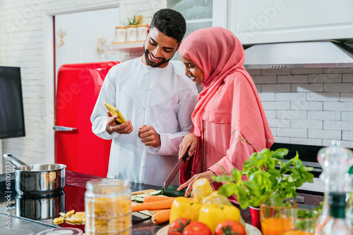 Photography happy middle-eastern married couple spending time together at home and wearing t
