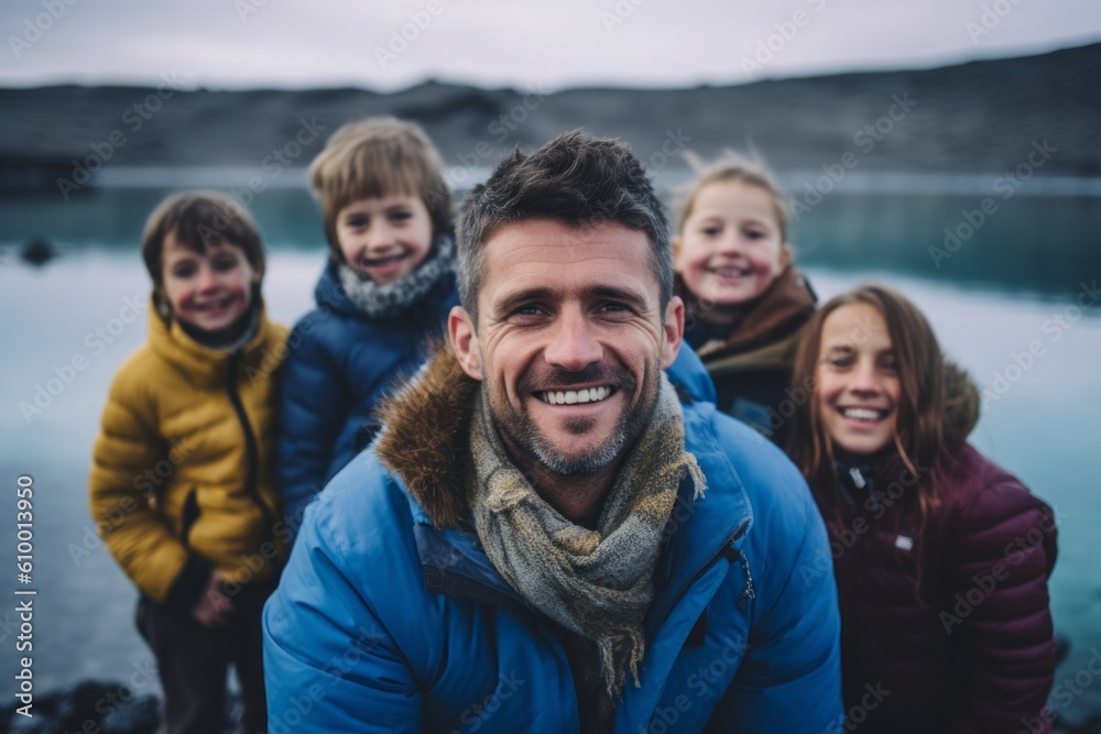 Portrait of a happy father with his kids on a hike in Iceland