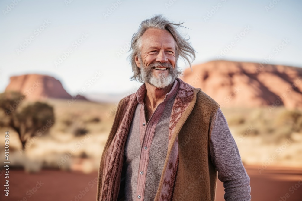 Lifestyle portrait photography of a pleased man in his 50s that is wearing a chic cardigan near the Uluru (Ayers Rock) in Northern Territory Australia . Generative AI