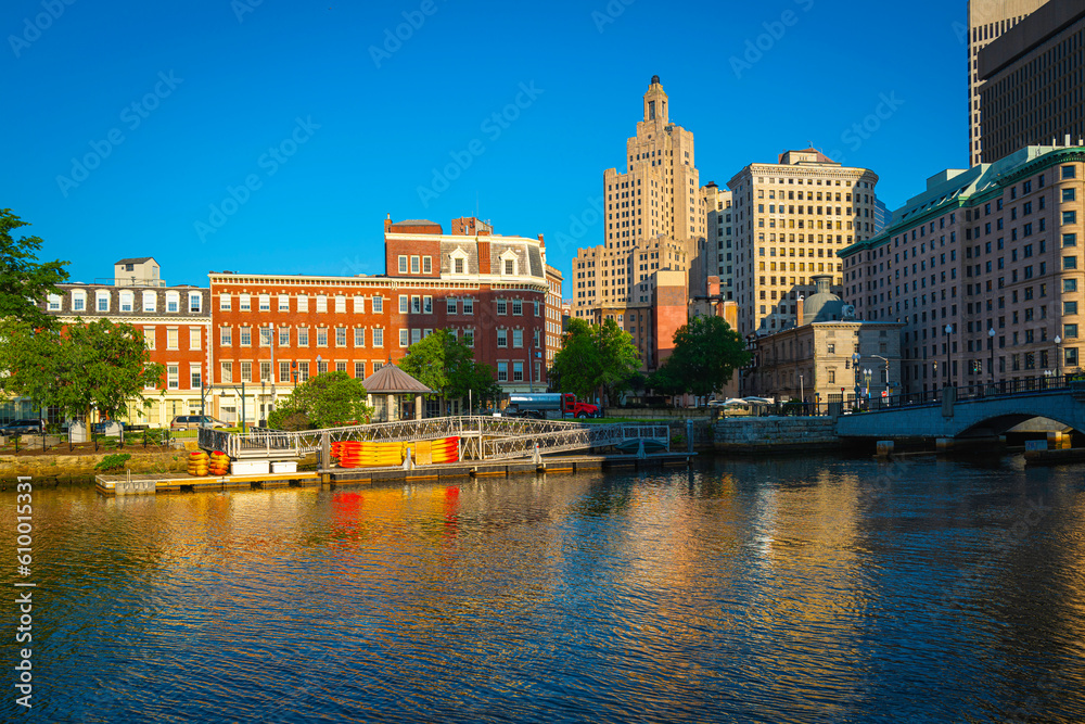 Downtown Providence skyline, city park, and building reflections at sunrise over the river in Rhode Island