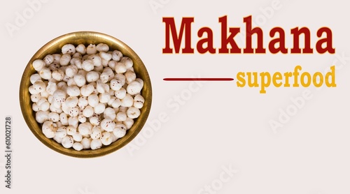 Makhana Superfood text written with fox nuts in copper plate in light background. Makhana or foxnut rich in protein and fiber and low in fat . copy space photo