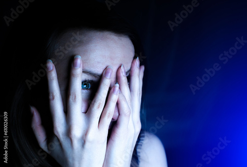 Canvas Print Woman is watching something scary. Close up scared girl face.
