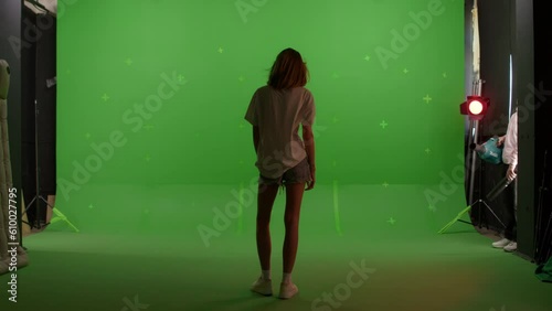 Silhouette young caucasian woman standing on the top of a mountain or roof watching the sunset with beautiful landscape on Green screen background, chroma key.