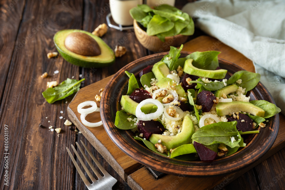 Vegan food, low calories dieting meal.Couscous with avocado, beet, green beans, spinach on a rustic wooden table. Copy space. Vegan food, low calories dieting meal.Couscous with avocado, beet, green beans, spinach on a rustic wooden table. Copy space.