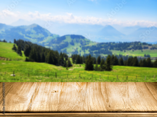 Blank wooden table and top view of the mountain and blue sky as background for product display