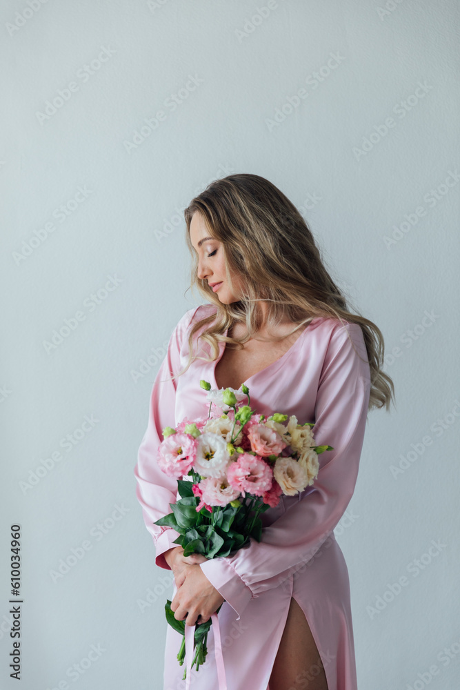 beautiful woman with flowers in a bright room