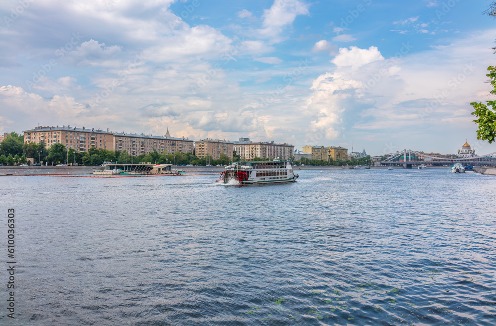 Cruise ship sails on the Moscow river in Moscow city center, popular place for walking. Cruise ship sails on the Moscow river in Moscow city center, popular place for walking.