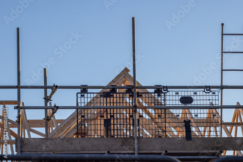 Newbuild house roof truss and scaffold. Residential construction industry image.