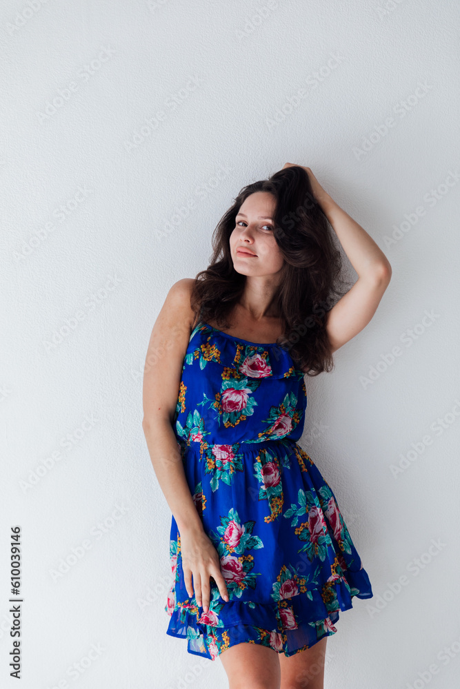 brunette in a floral dress on a white background brunette in a floral dress on a white background