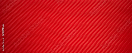 Photo of the texture of red sports carbon fiber. Rectangular background made of carbon film. Sports tuning of the car interior.