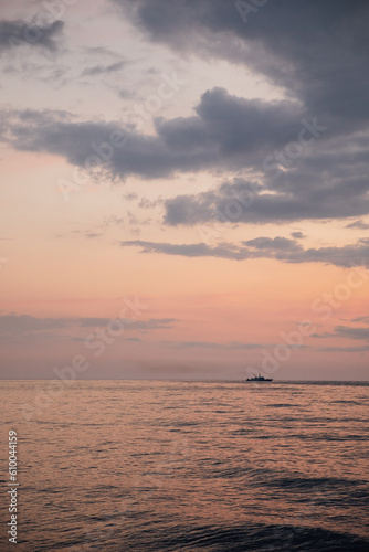 beautiful sea ship in the distance at sunset nature sea voyage
