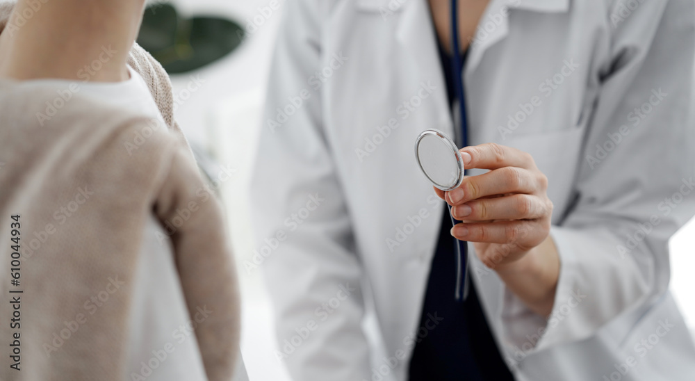 Doctor and a kid patient. Physician is holding stethoscope and ready to examine boy. Perfect health concept in medicine. Doctor and a kid patient. Physician is holding stethoscope and ready to examine boy. Perfect health concept in medicine.