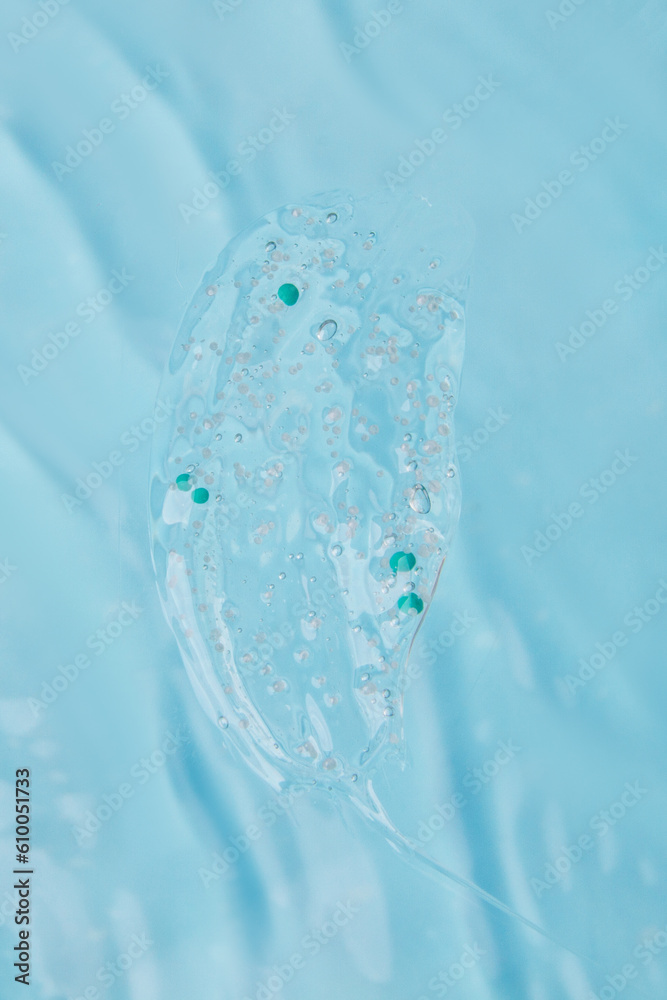 clear wash gel with granules on the background of blue water clear wash gel with granules on the background of blue water