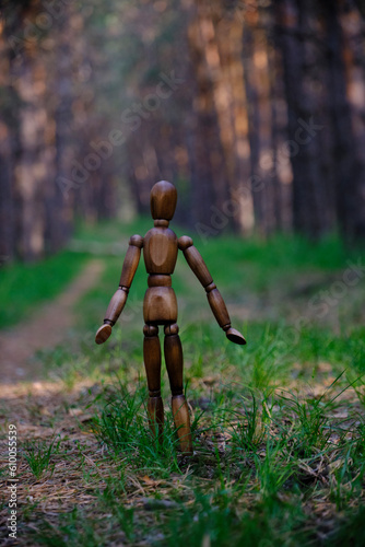 Lonely mannequin wandering through forest.Concept ecological cleanliness and relaxation from urban everyday life.
