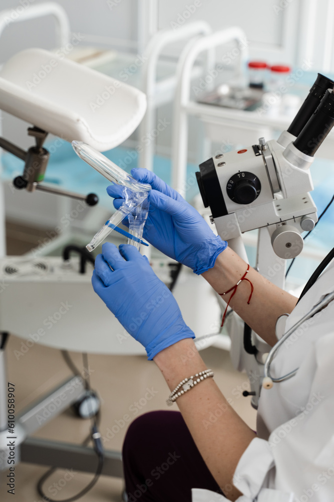 Fototapeta premium Speculum close-up in gynecologist hands for colposcopy procedure to closely examine cervix, vagina and vulva of girl in gynecology clinic.