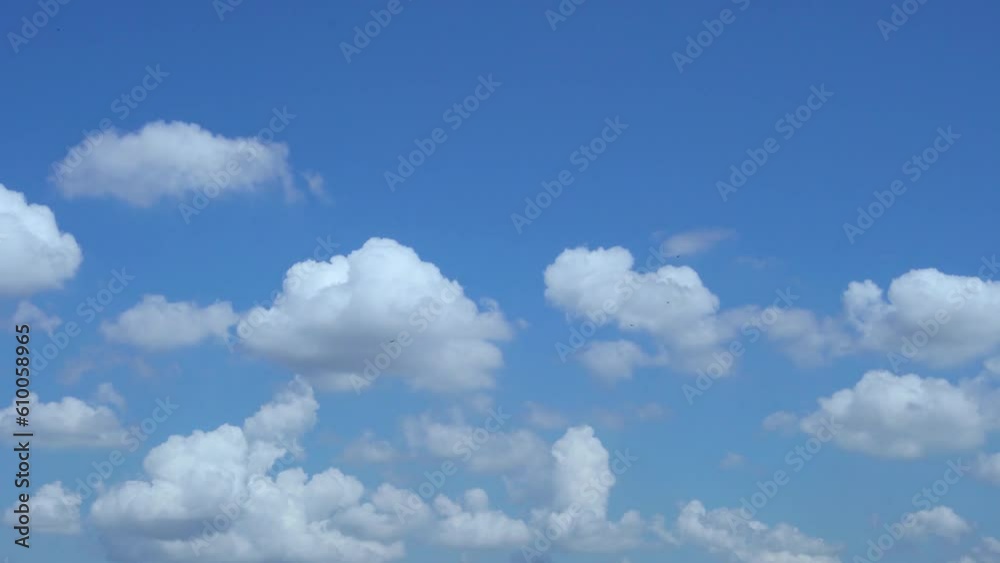 Blue Sky and Soaring Fluffy White Clouds Slow Motion. Time Lapse Of Slowly Floating White Cumulus Clouds In A Summer Sunny Blue Skyscraper, White Cloudscape, Cloudy Blue Sky, Heaven, Firmament, 4K. Blue Sky and Soaring Fluffy White Clouds Slow Motion. Time Lapse Of Slowly Floating White Cumulus Clouds In A Summer Sunny Blue Skyscraper, White Cloudscape, Cloudy Blue Sky, Heaven, Firmament, 4K.