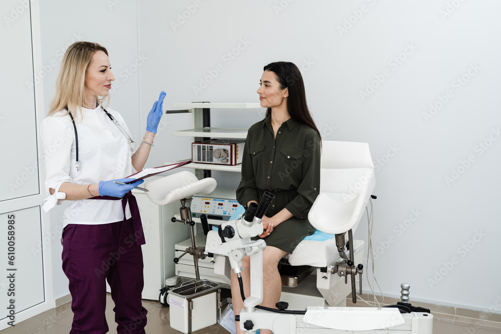 Consultation with gynecologist before colposcopy and pap test procedure to closely examine cervix, vagina and vulva of girl in gynecology clinic. Consultation with gynecologist before colposcopy and pap test procedure to closely examine cervix, vagina and vulva of girl in gynecology clinic.