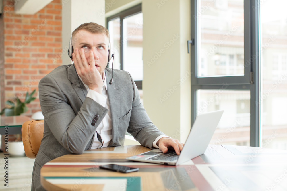 feeling bored, frustrated and sleepy after a tiresome. telemarketer concept feeling bored, frustrated and sleepy after a tiresome. telemarketer concept