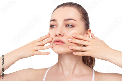 Young woman makes massage herself on face. photo