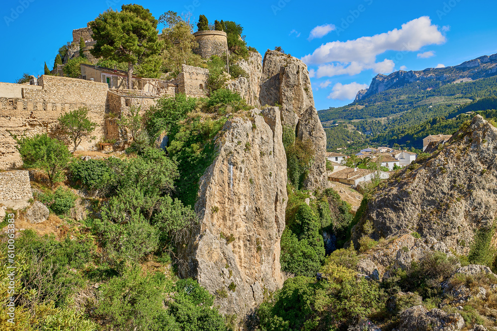 Guadalest Castle on top of a rock with a bright blue sky