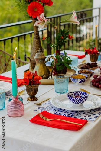 Outdoors, summer dinner at the balcony served for four persons served with inspiration from Morocco