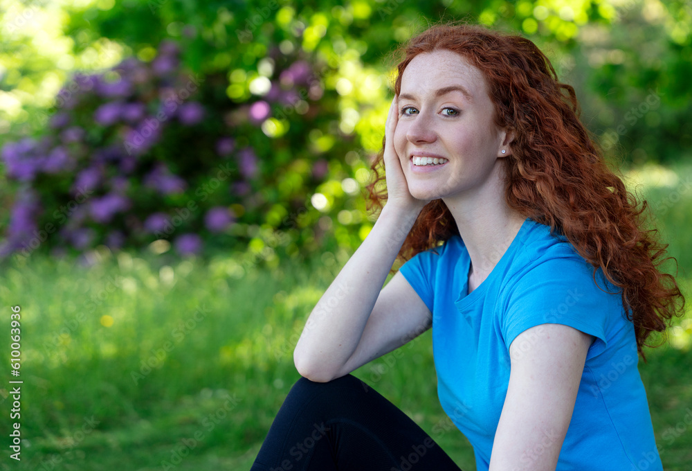 Happy Woman Resting After Exercising In Park. Fitness, sport and exercise concept Happy Woman Resting After Exercising In Park. Fitness, sport and exercise concept
