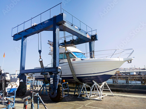 Photo motorboat yacht  in shipyard  for repair and maintenance in marina port