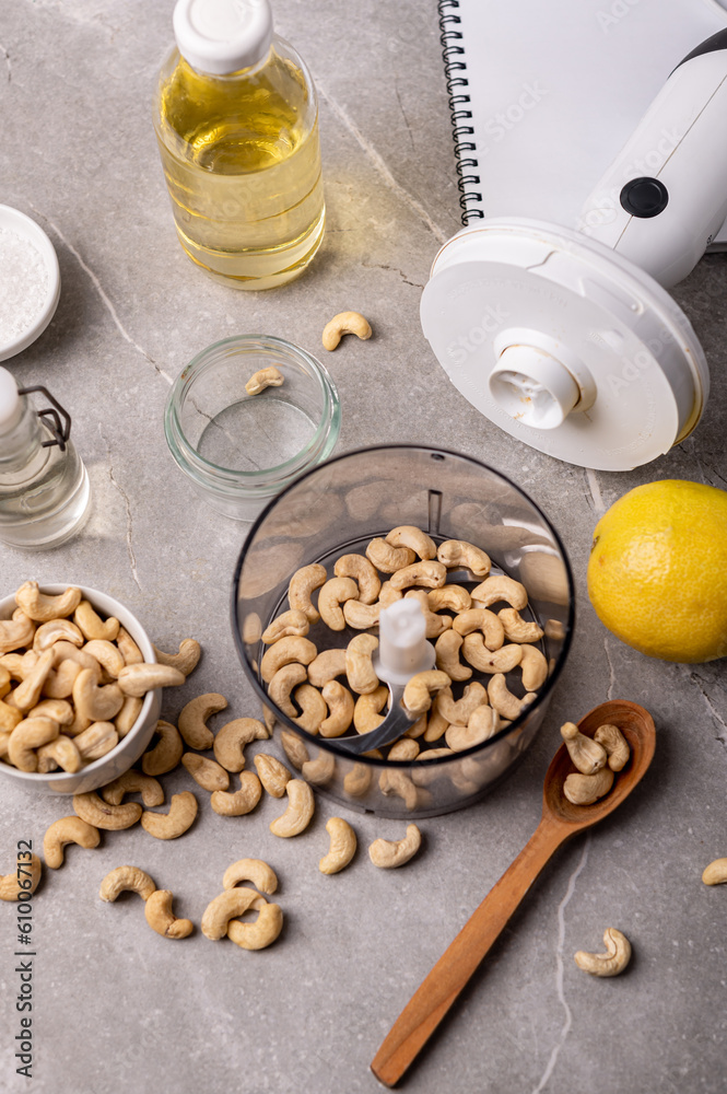 Cashew nut cream cheese in a white bowl and cooking ingredients Cashew nut cream cheese in a white bowl and cooking ingredients