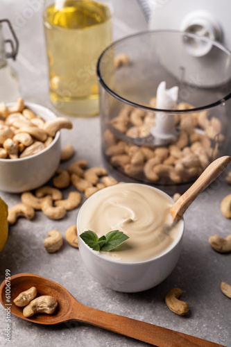 Cashew nut cream cheese in a white bowl and cooking ingredients