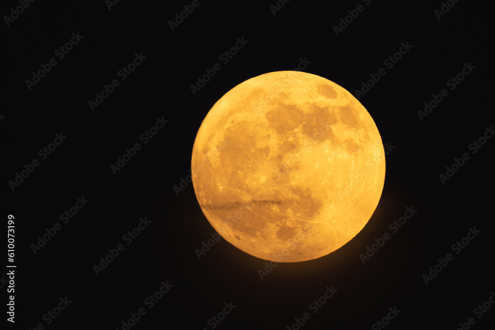Super strawberry moon, reddish full moon on a summer night. full moon with clouds ahead Super strawberry moon, reddish full moon on a summer night. full moon with clouds ahead