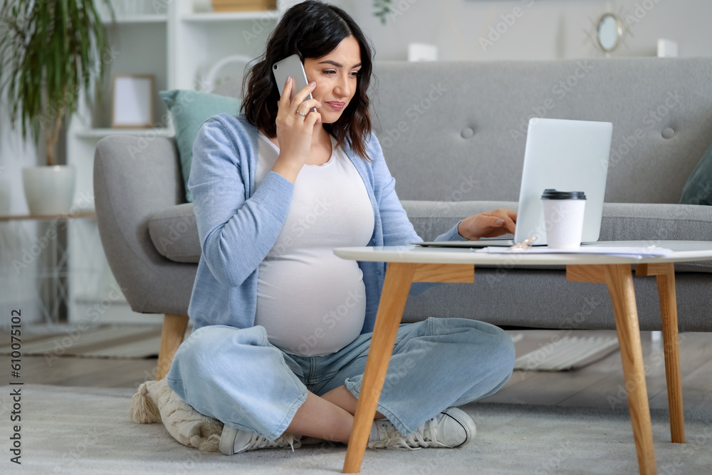Working pregnant woman talking by mobile phone at home Working pregnant woman talking by mobile phone at home