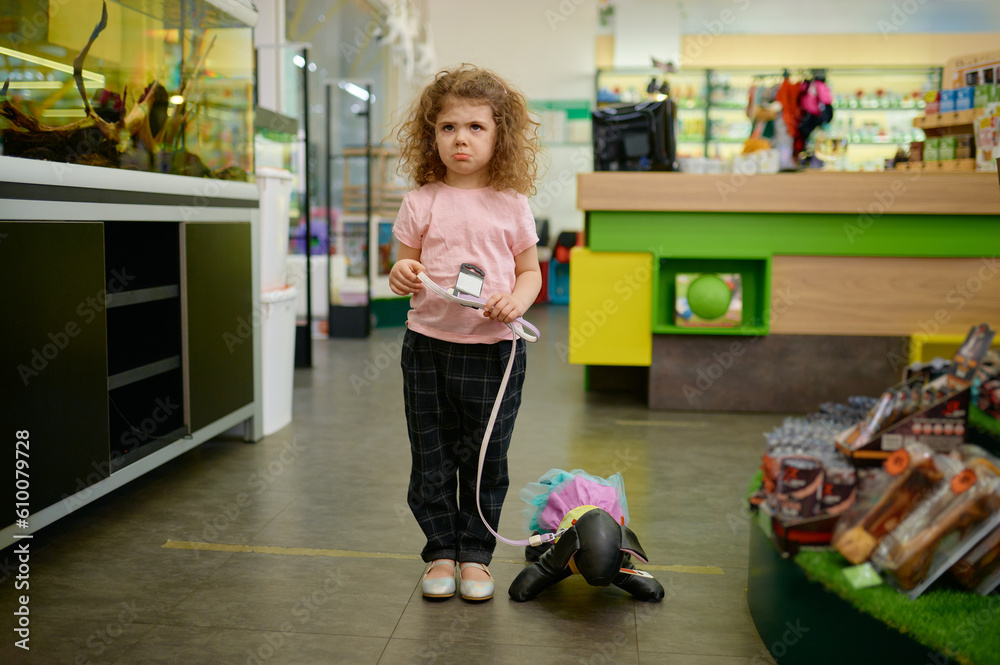 Little girl child at pet shop with toy dog Little girl child at pet shop with toy dog