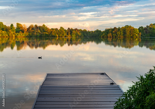 Fototapeta Naklejka Na Ścianę i Meble -  Sunset panorama of the lake shore of the Mere with a perfect lake reflection in Ellesmere in Shropshire