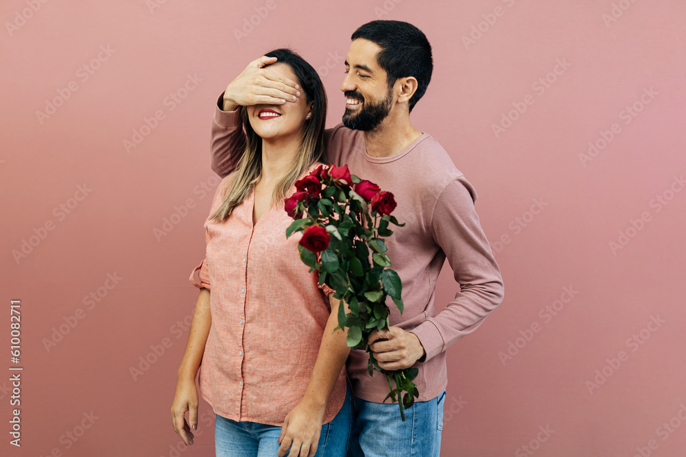 A loving couple celebrates Valentine's Day as the boyfriend gifts his girlfriend a bouquet of roses. A loving couple celebrates Valentine's Day as the boyfriend gifts his girlfriend a bouquet of roses.