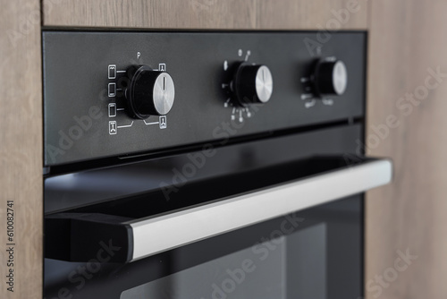 Wooden furniture with modern built-in oven in kitchen