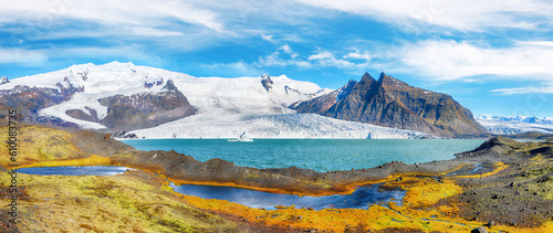 Breathtaking View of Fjallsarlon Glacier Lagoon and colour moss at foreground.