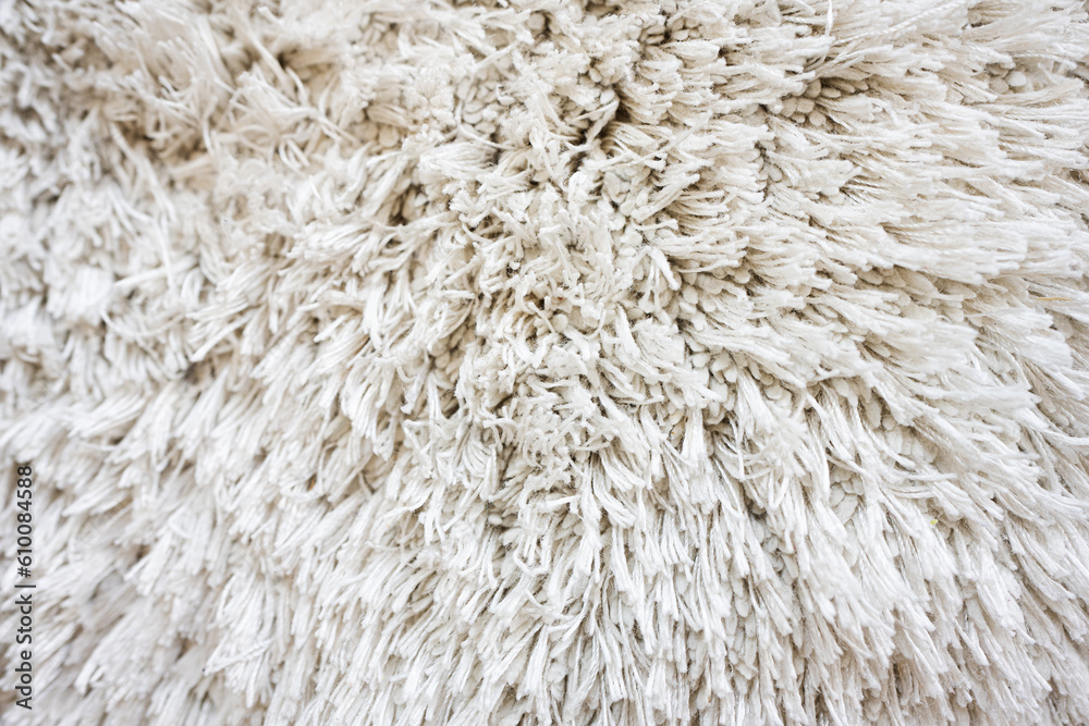 Close up white fluffy carpet texture background. Close up white fluffy carpet texture background.