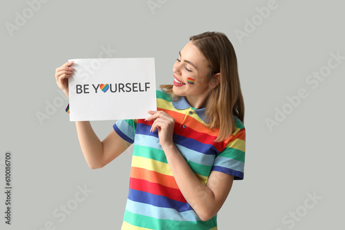 Young woman holding paper w...