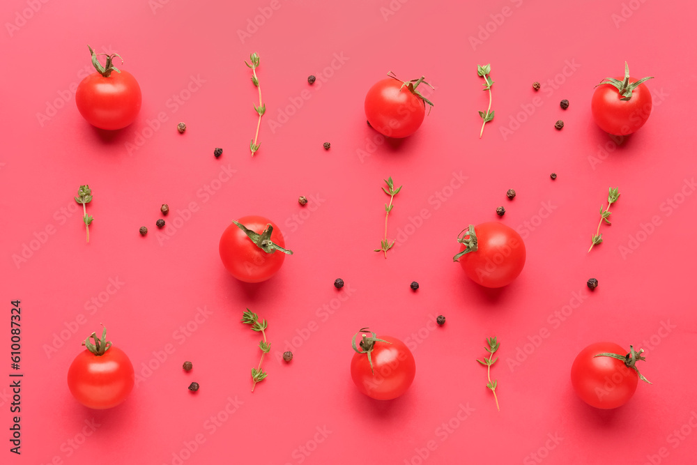Composition with ripe cherry tomatoes, thyme and peppercorn on red background Composition with ripe cherry tomatoes, thyme and peppercorn on red background